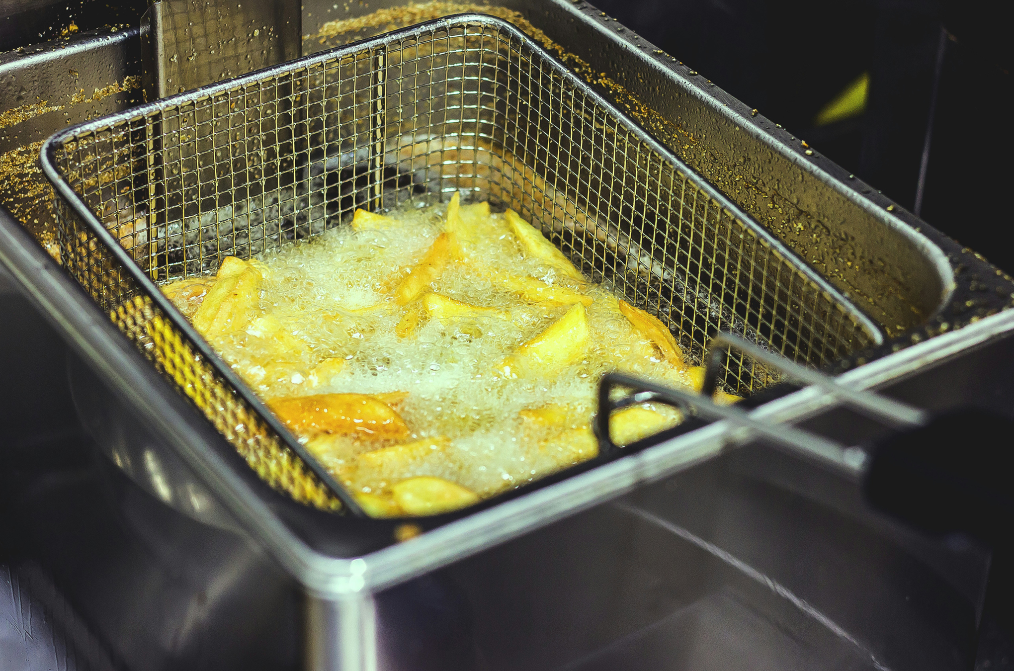 French fries being fried in oil